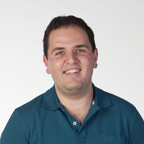 Headshot photo of Rehan wearing a teal polo